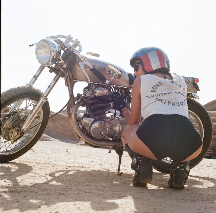 A playful frame from Girls on a motorcycle — online in Tabuk